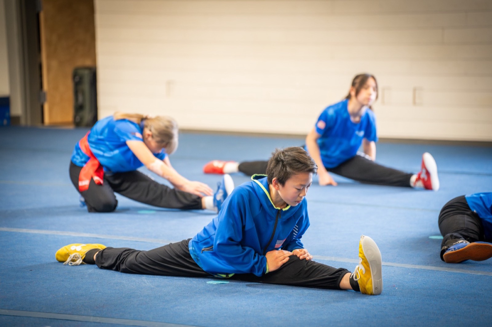 A class stretches together on the training floor