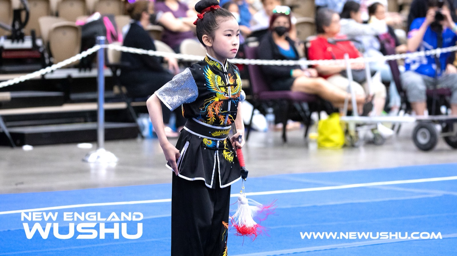 A young New England Wushu athlete performs a straight sword routine