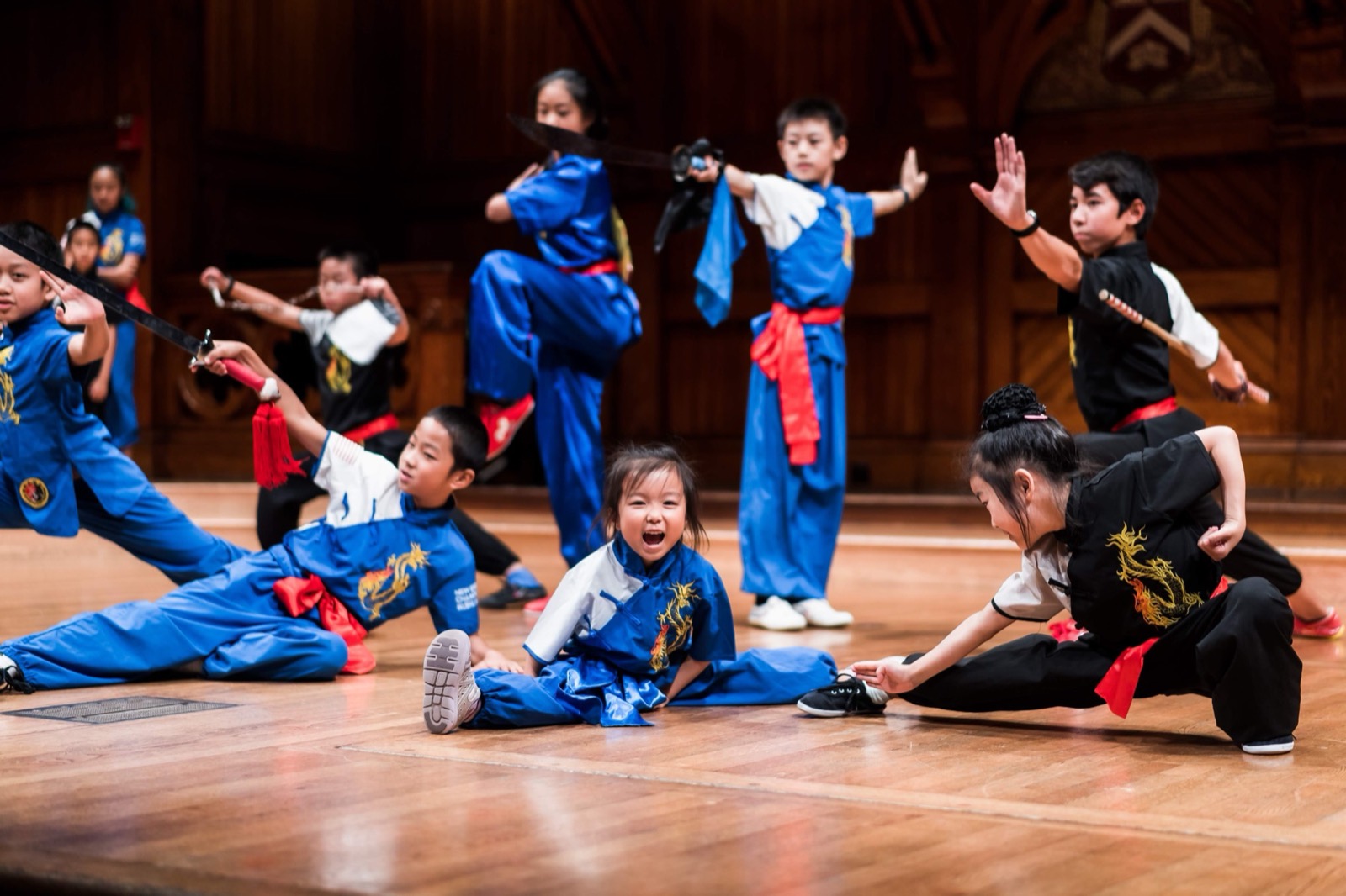 Students strike a group pose at a stage performance
